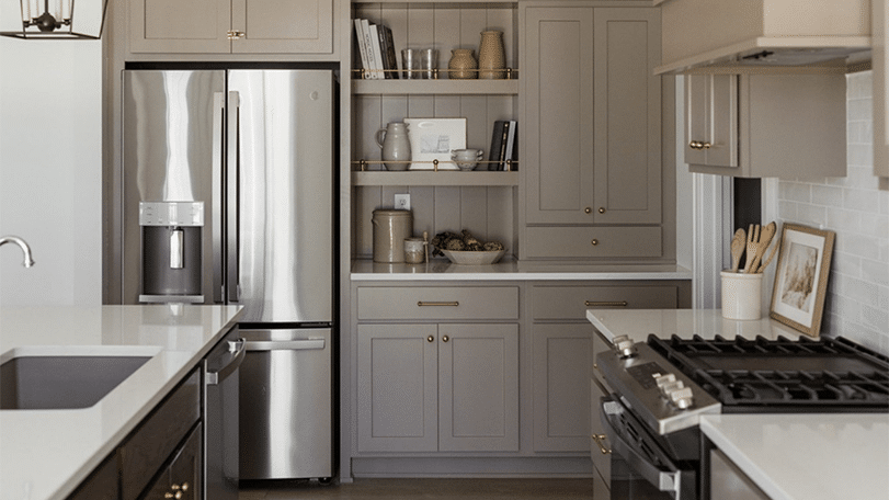 Modern kitchen with gray refinished cabinets, stainless steel appliances, and gas range