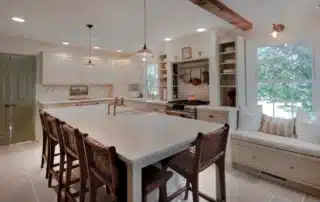 Spacious kitchen featuring a large island, custom cabinetry, and natural light