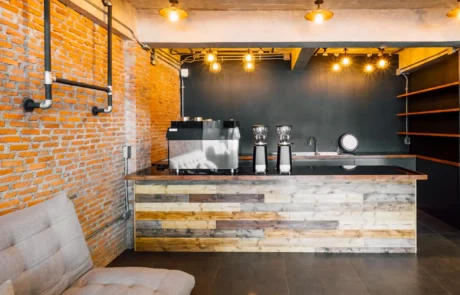 Modern industrial coffee shop bar counter with exposed brick wall and wooden finishes in Annapolis MD