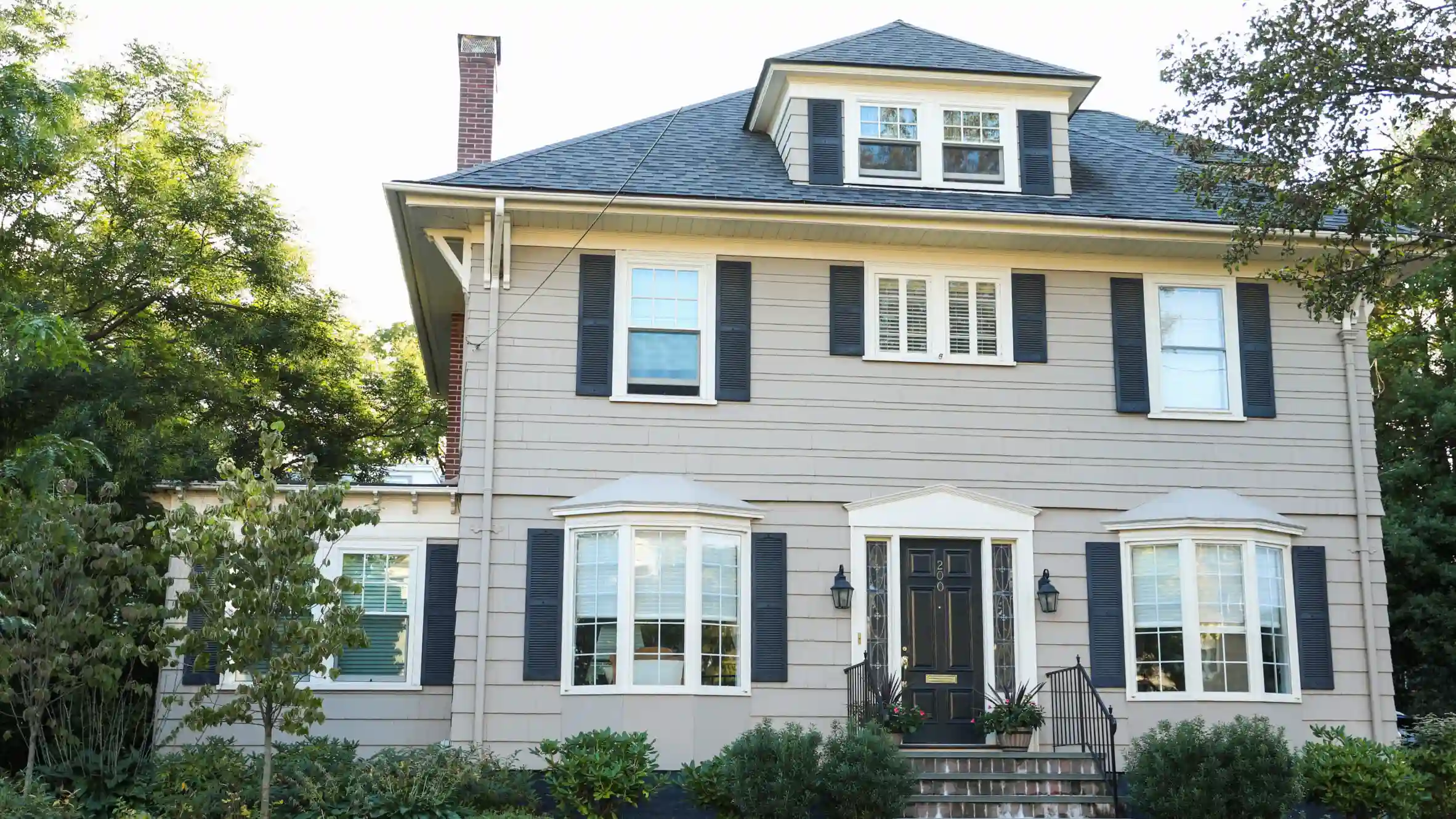 Classic two-story house with grey siding and black shutters in Annapolis MD