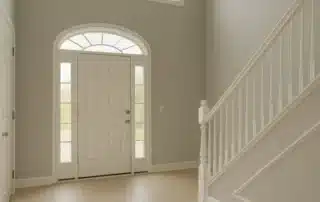 Interior Painting Neutral Grey Foyer Annapolis Md Foyer with neutral grey walls, white trim, tiled floor, and staircase
