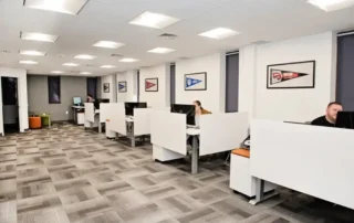 Modern office interior with white cubicles and patterned carpet in Annapolis Md