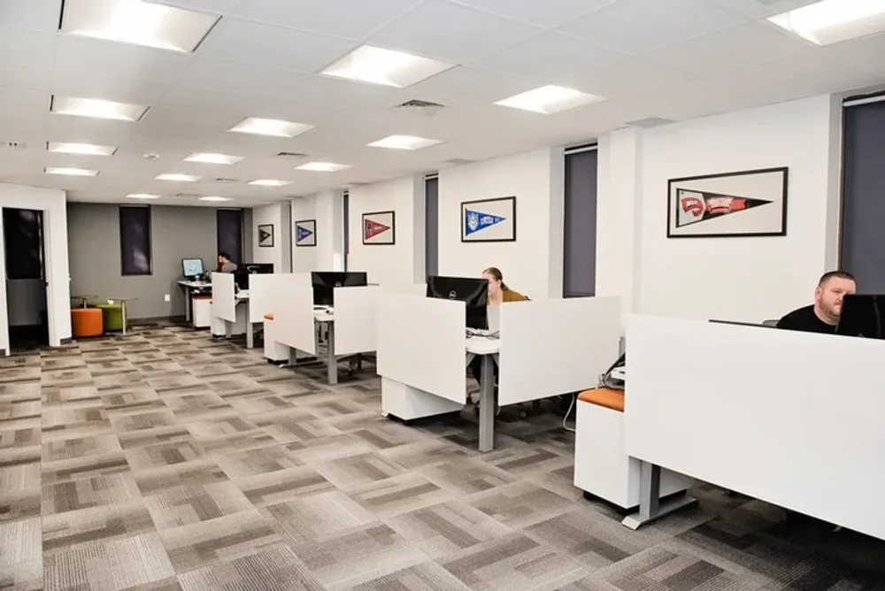 Modern office interior with white cubicles and patterned carpet in Annapolis Md