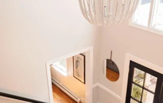 Interior Painting Foyer Staircase Annapolis Md High-angle view of a residential foyer with neutral walls, staircase, and chandelier