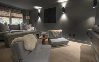 Residential Grey Media Room Interior Painting Annapolis Md Grey media room with upholstered chairs, sofa, coffee table, and wall sconces in Annapolis Md