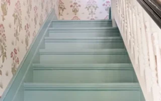 Residential Interior Painting Blue Stairs Annapolis Md Staircase painted in soft blue with floral patterned wallpaper and white railing in Annapolis Md