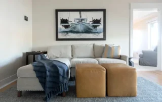 Residential Interior Painting Cozy Living Room Annapolis Md Light grey sectional sofa with leather ottomans and nautical art in a residential living room