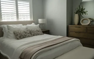 Residential Interior Painting Grey Bedroom Annapolis Md Cozy neutral bedroom with grey walls, white plantation shutters, and wooden dresser