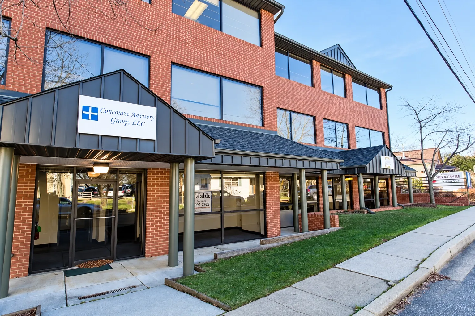 Red brick commercial office building with metal entrance awnings