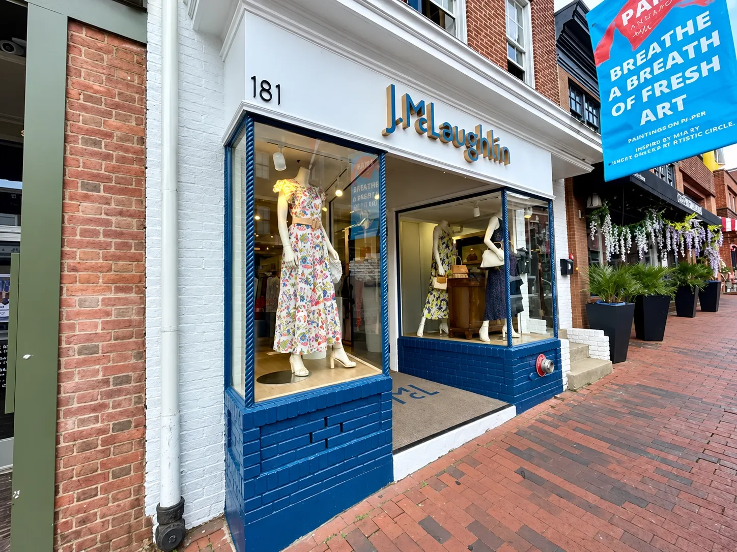 J.McLaughlin retail storefront with white trim and navy blue window panels