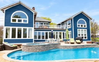 navy-blue-house-exterior-swimming-pool Navy blue house with white trim overlooking a swimming pool